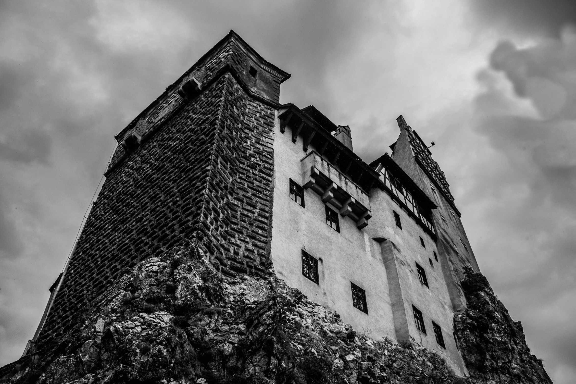 a black and white photo of a castle, by Matthias Weischer, pexels contest winner, renaissance, dracula's castle, low angle!!!!, brutalist architecture building, сastle on the rock