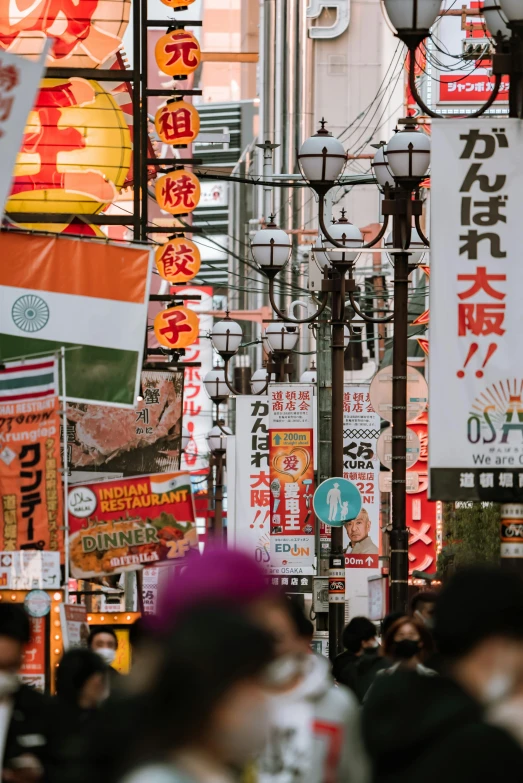 a crowd of people walking down a street next to tall buildings, trending on unsplash, ukiyo-e, flags, hindu aesthetic, bright signage, square