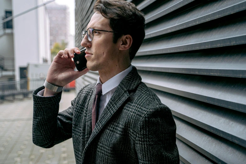 a man in a suit talking on a cell phone, inspired by Harrington Mann, pexels contest winner, renaissance, man with glasses, agent cooper, medium shoot, matej ‘retro’ jan