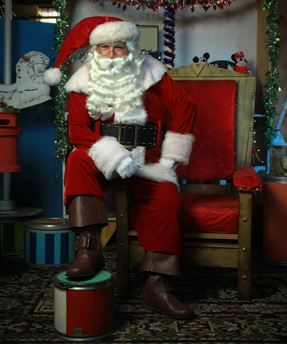 a man dressed as santa claus sitting on a chair, pexels, photorealism, animatronic, leather clothing and boots, hi-res, multiple stories