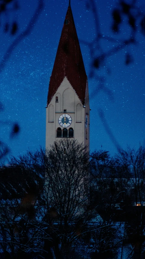 a clock that is on the side of a building, an album cover, by Sebastian Spreng, unsplash, romanesque, winter night, church, low quality photo, thumbnail