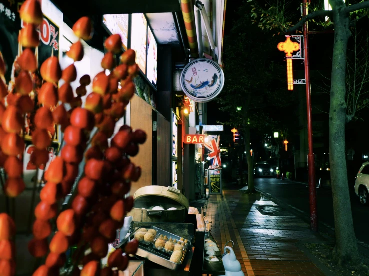 a clock on the side of a building next to a street, unsplash, ukiyo-e, food stall, humid evening, 2 0 0 0's photo, fan favorite