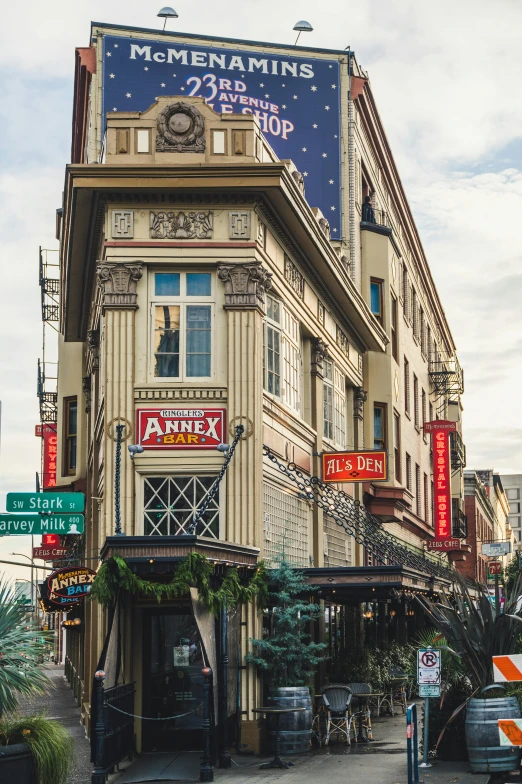 a bus driving down a street next to a tall building, a photo, trending on pexels, art nouveau, awnings, tavern, louisiana, washington main street