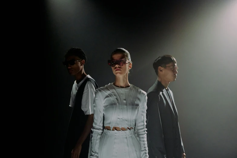 a group of people standing next to each other on a stage, unsplash, bauhaus, futuristic fashion, wearing light, kim hyun joo, blind