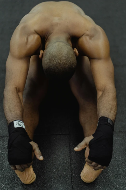 a man doing a handstand in a gym, an album cover, by Jessie Alexandra Dick, laying down with wrists together, fleshy musculature, black human spine, photo of a model