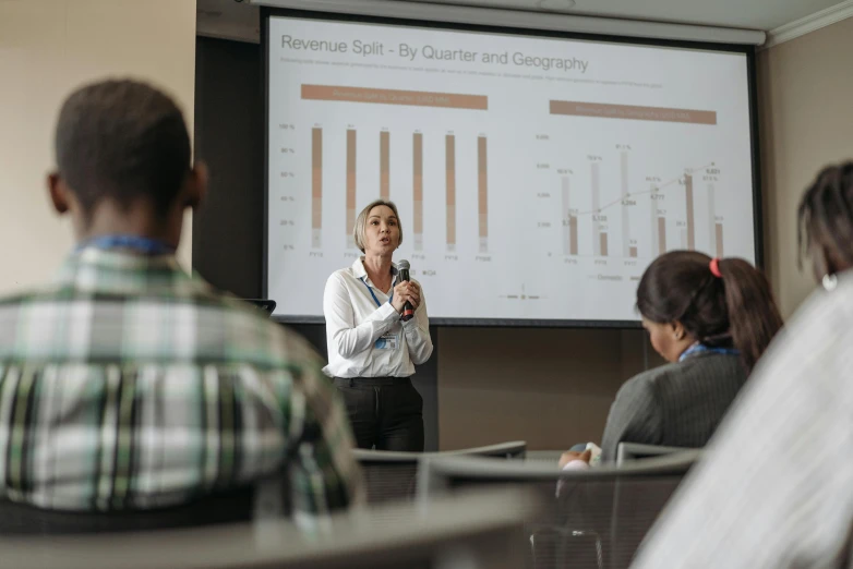 a woman giving a presentation to a group of people, data, wētā fx, multiple stories, crisp focus