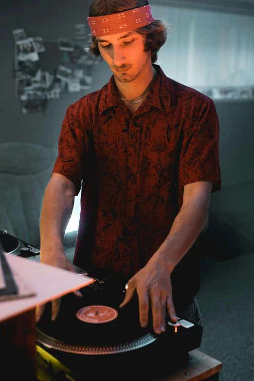 a man in a red shirt playing a record on a turntable, process art, with hawaiian shirt, lachlan bailey, **cinematic, studious