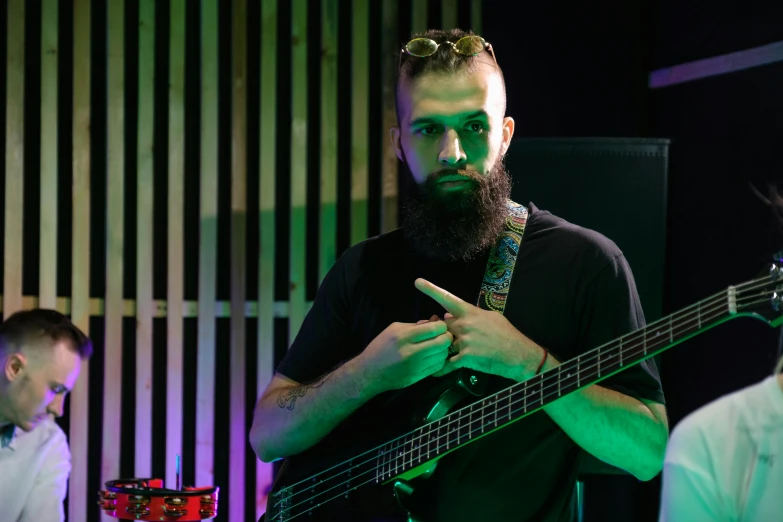 a man with a beard playing a bass guitar, ash thorp khyzyl saleem, avatar image