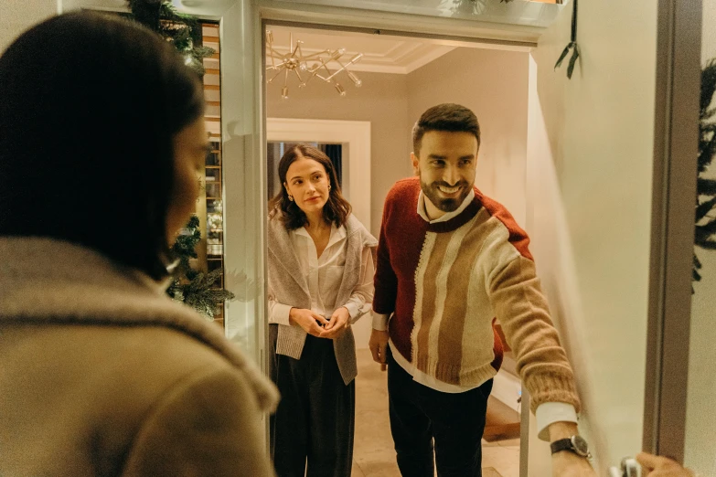 a man and a woman standing in front of a mirror, airbnb, wearing festive clothing, about to enter doorframe, profile image