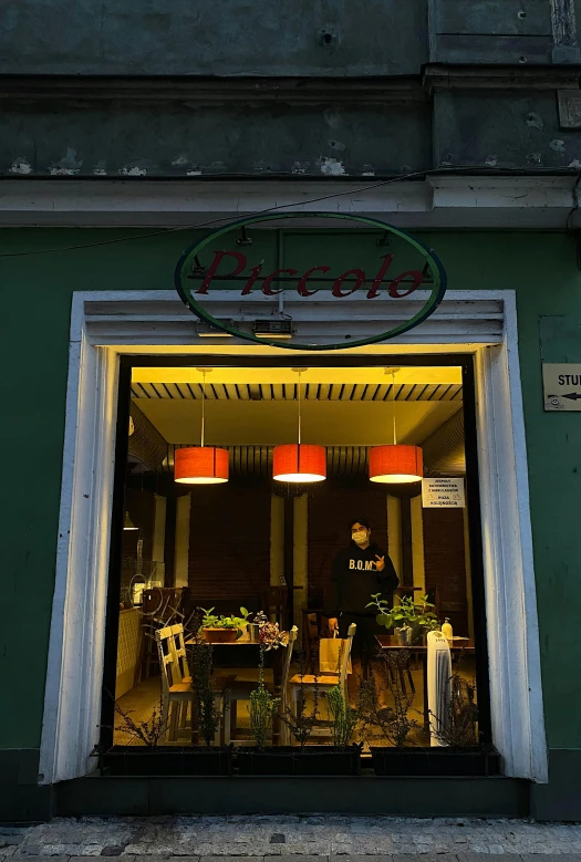 a couple of people that are standing in front of a building, by László Paál, busy restaurant, green and orange theme, rococco, outside lighting