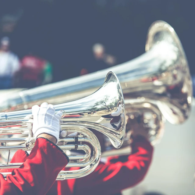 a man in a red jacket playing a silver trumpet, pexels contest winner, instagram post, parade floats, retro effect, closeup of arms