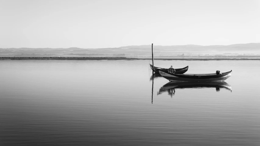 a black and white photo of a boat in the water, a black and white photo, pexels contest winner, minimalism, on the calm lake, fisherman, 4k serene, taras susak