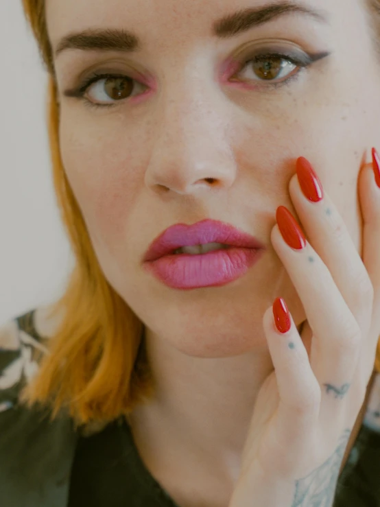 a close up of a person with red nails, inspired by Elsa Bleda, hyperrealism, pink lips, nonbinary model, sad christina hendricks, with tattoos