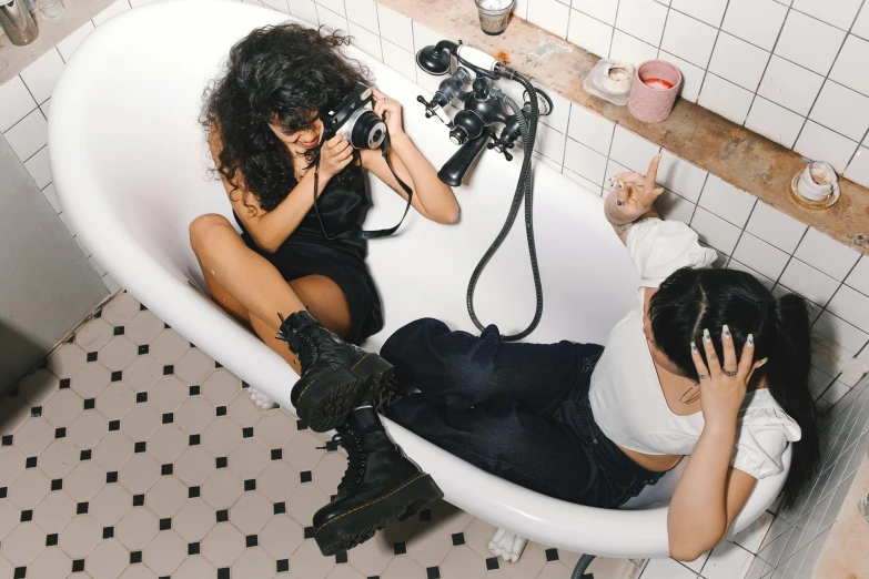 a woman taking a picture of another woman in a bathtub, trending on pexels, visual art, ariel perez, with nikon cameras, jordan grimmer and natasha tan, making out