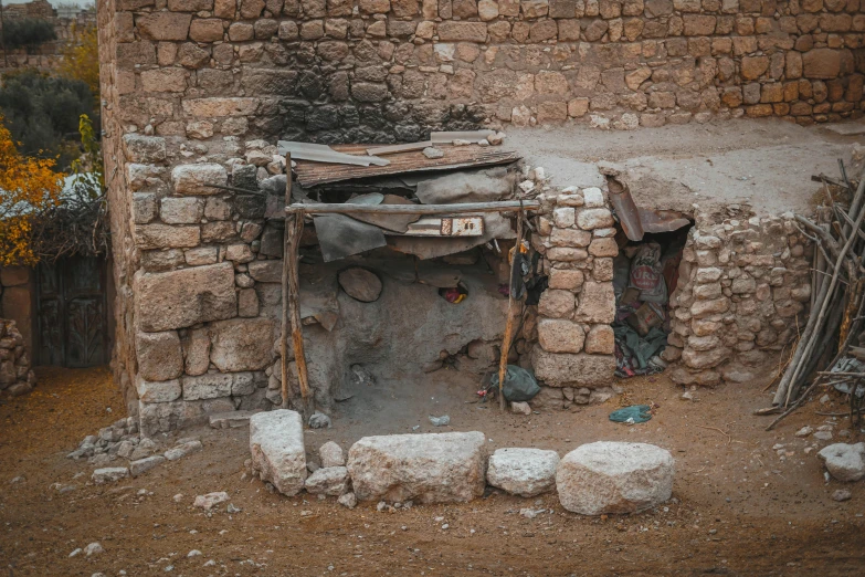 a stone oven sitting in the middle of a dirt field, pexels contest winner, les nabis, shanty town, middle eastern details, clothed in ancient, old apartment