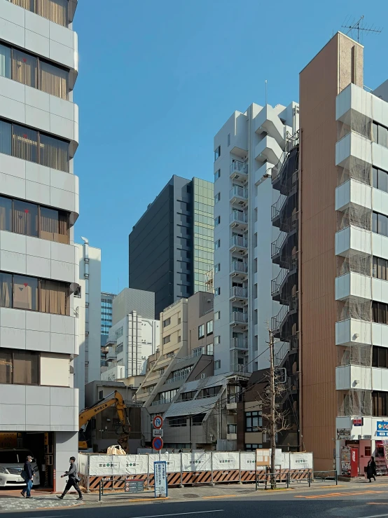 a group of tall buildings sitting on the side of a road, a photo, inspired by Takeuchi Seihō, shin hanga, demolition, photo from 2022, hyperdetailed!, japanese architecture