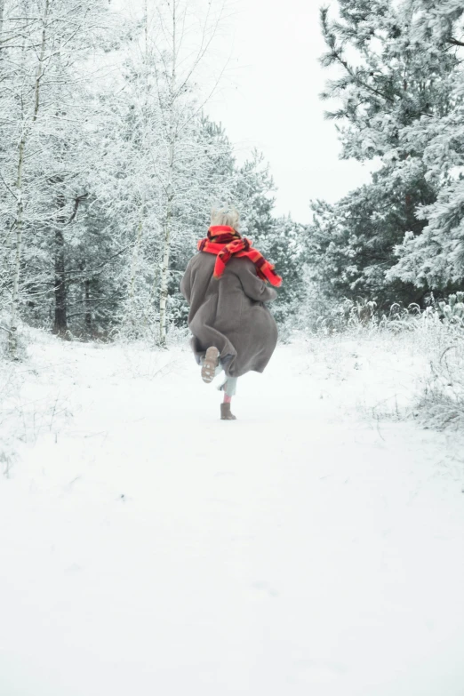 a person running through a snow covered forest, by Daarken, shutterstock contest winner, human dressed as a bull, carrying big sack, grey, he‘s wearing a red scarf