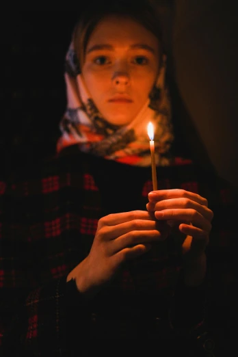 a woman holding a lit candle in her hands, hurufiyya, photo taken in 2 0 2 0, adim kashin, instagram photo, concern