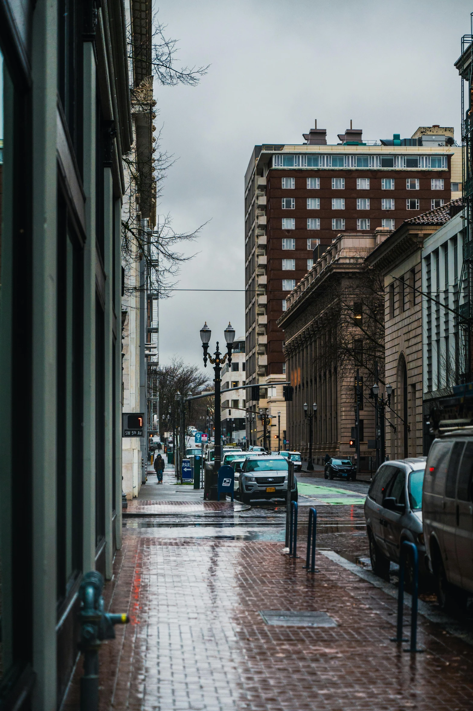 a city street lined with parked cars on a rainy day, a photo, visual art, portland oregon, 2019 trending photo, neo classical architecture, square