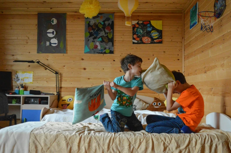 a couple of kids sitting on top of a bed, by Jaakko Mattila, pexels contest winner, visual art, boy's room, in a cabin, avatar image, mid - action