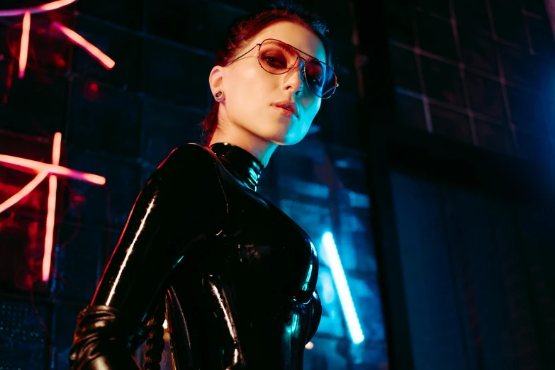 a woman in a latex outfit standing in front of a neon sign, inspired by Elsa Bleda, trending on pexels, bauhaus, dark glasses, glowing lens flare wraith girl, sasha grey, photograph of a techwear woman