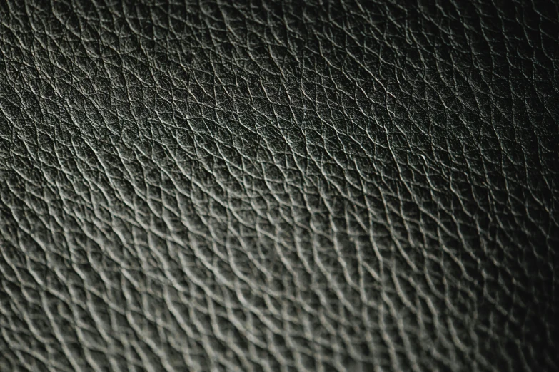 a close up of a black leather surface, taken with a canon eos 5d, alessio albi, patterned, curved