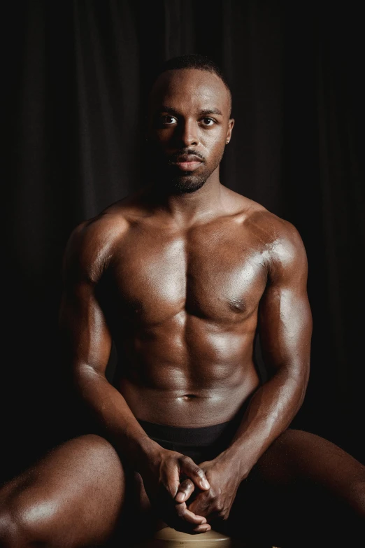 a man with no shirt sitting on a stool, an album cover, by Jessie Alexandra Dick, pexels contest winner, black main color, bodybuilder body, 30 year old man :: athletic, model with attractive body