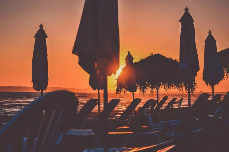 lounge chairs and umbrellas on a beach at sunset, pexels contest winner, renaissance, thumbnail, mediterranean beach background, profile image, ((sunset))