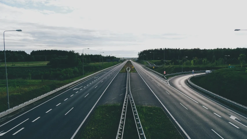 a highway filled with lots of traffic next to a forest, a picture, unsplash, realism, runway, broken down, thumbnail, large format