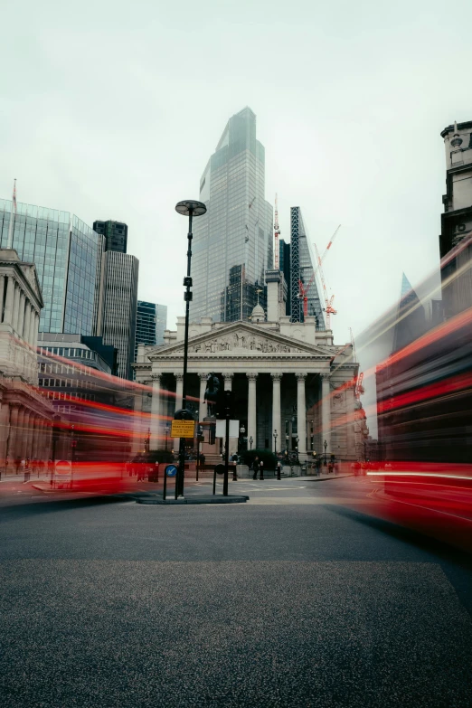 a double decker bus driving down a street next to tall buildings, by Jay Hambidge, pexels contest winner, on a great neoclassical square, timelapse, pantheon, grey