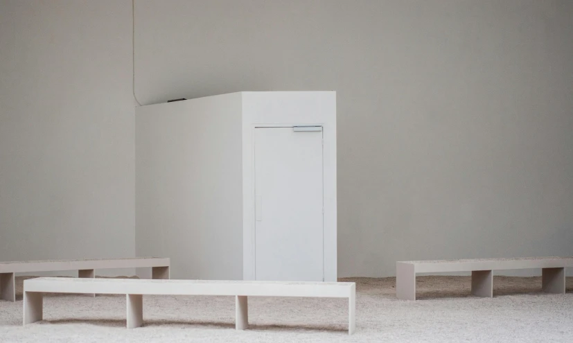 a refrigerator sitting next to two benches in a room, inspired by Rachel Whiteread, unsplash, minimalism, white building, wooden banks, angled, 3 doors