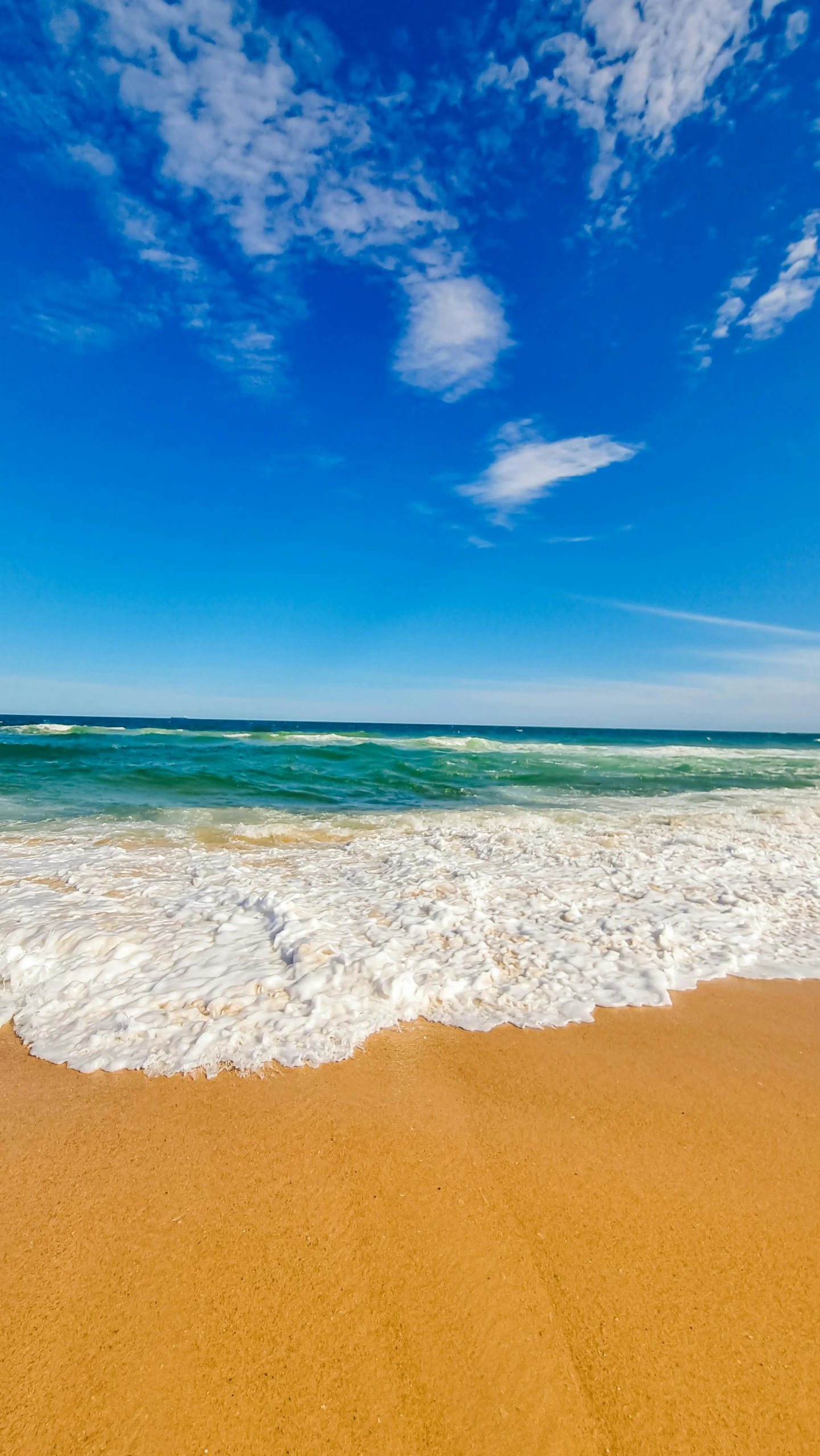 a large body of water sitting on top of a sandy beach, profile image, beachfront, afternoon time