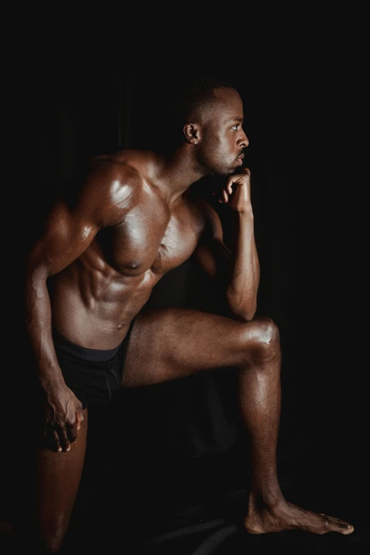 a man posing for a picture in the dark, inspired by Terrell James, sporty physique, chocolate. rugged, profile image, thighs