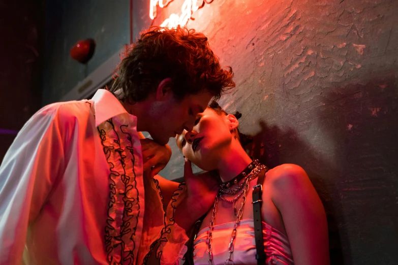 a man and a woman standing next to each other, inspired by Nan Goldin, renaissance, in a nightclub, reylo kissing, fear and loathing in las vegas, getty images