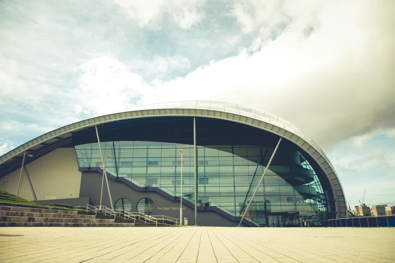 a person riding a skateboard in front of a building, inspired by Zaha Hadid, unsplash, academic art, stadium landscape, chesterfield, aquarium, “wide shot