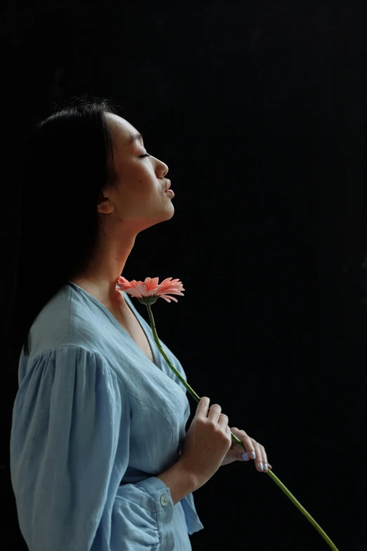 a woman in a blue dress holding a pink flower, by Shang Xi, hyperrealism, profile image, still photograph, large)}], looking upwards