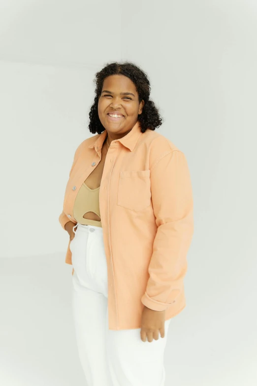 a woman in an orange shirt and white pants, wearing a white button up shirt, muted pastel colors, promo image, plus-sized