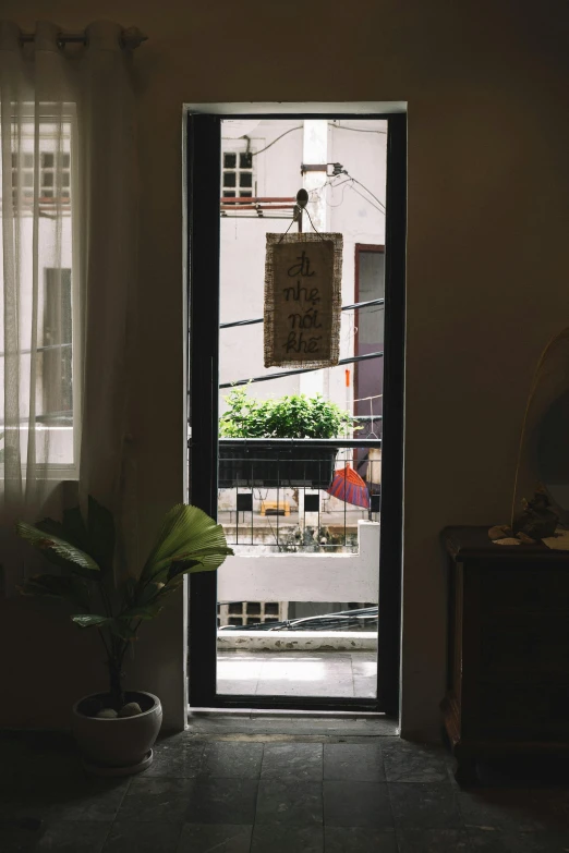 a door is open in a dark room, by Tan Ting-pho, light and space, window sill with plants, city morning, shop front, two hang
