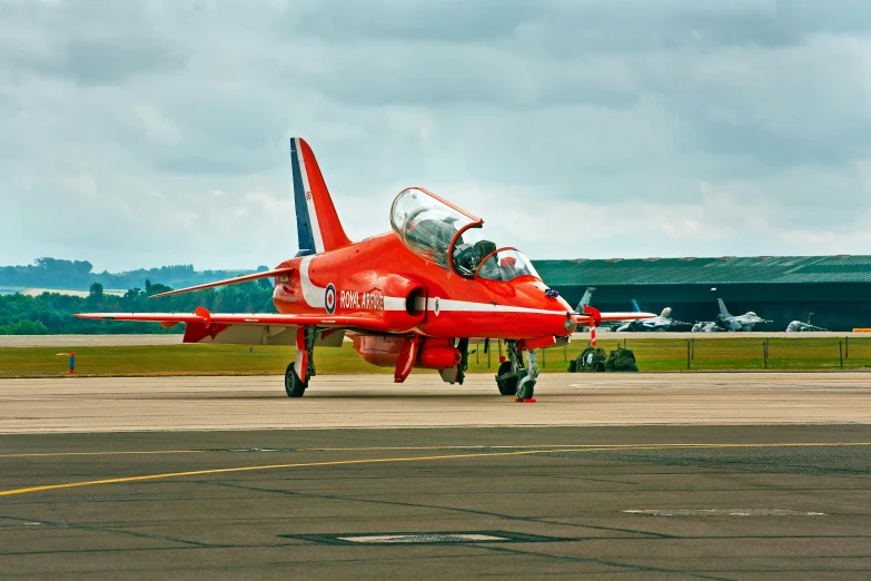 a red and white jet sitting on top of an airport tarmac, by Paul Bird, pexels contest winner, high speed action, wearing a red captain's uniform, festivals, a wooden