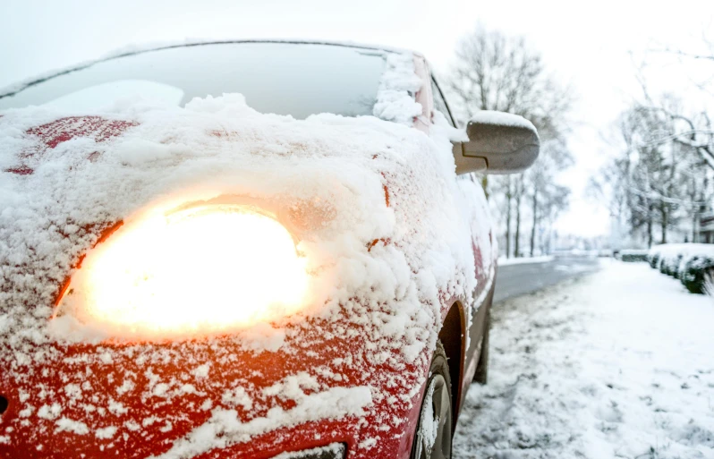 a red car covered in snow on a snowy street, by Haukur Halldórsson, closeup photograph, square, high quality photo, scientific