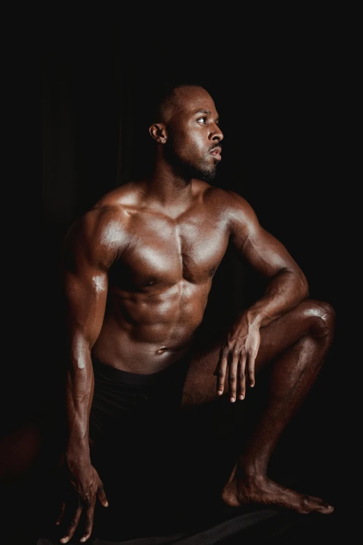 a man sitting on a skateboard in the dark, an album cover, by Jessie Alexandra Dick, bodybuilder physique, black main color, proud, kevin hart