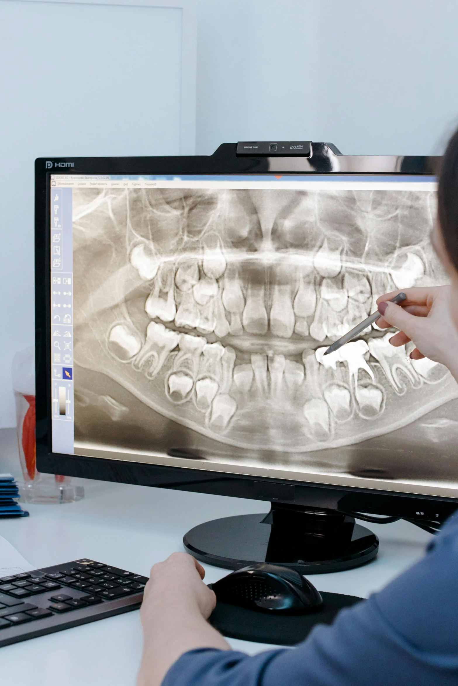 a woman sitting at a desk in front of a computer, a digital rendering, hyperrealism, uniform teeth, extreme panoramic, bone, instagram post
