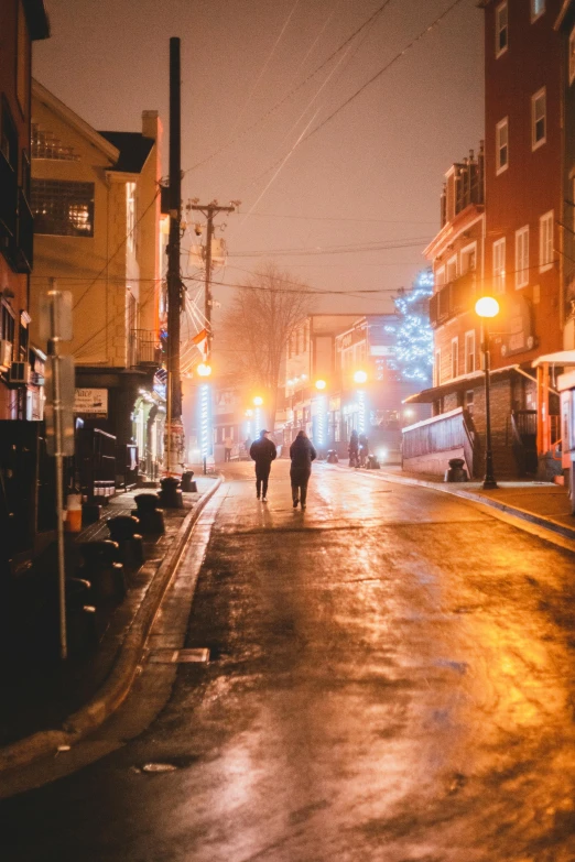 a person walking down a street at night, in the winter, quaint, man and woman walking together, jenna barton