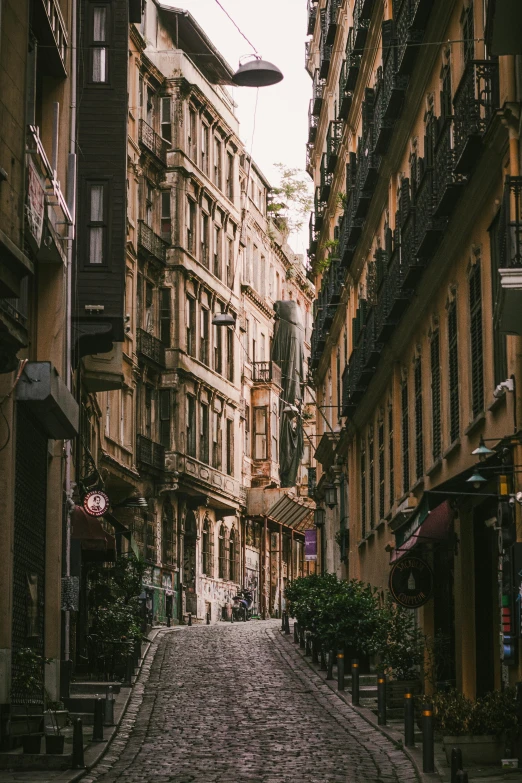 a cobblestone street in an old european city, pexels contest winner, naples, tall buildings on the sides, savannah, spanish