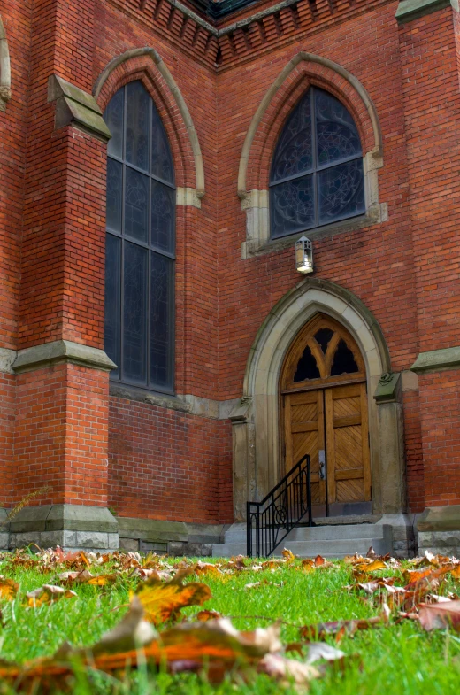 a red fire hydrant sitting on top of a lush green field, romanesque, tall arched stone doorways, fall foliage, dark gloomy church, slide show