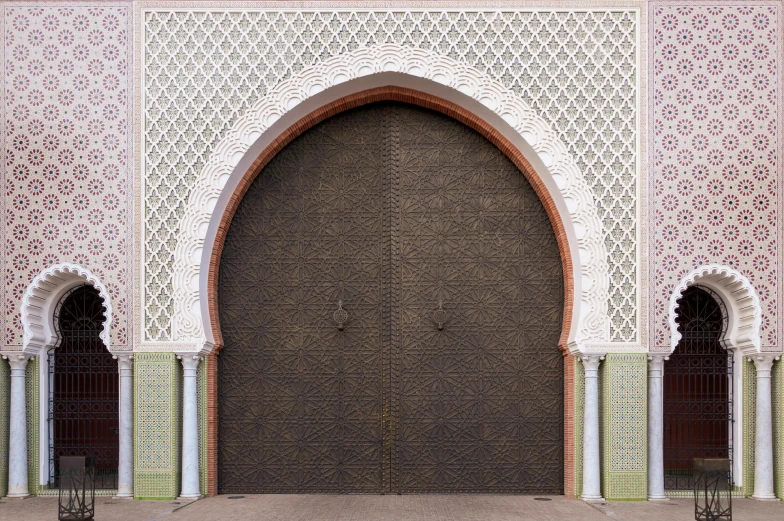 a person sitting on a bench in front of a building, inspired by Alberto Morrocco, pexels contest winner, arabesque, iron arc gate door texture, moroccan mosque, highly detailed texture render, ffffound