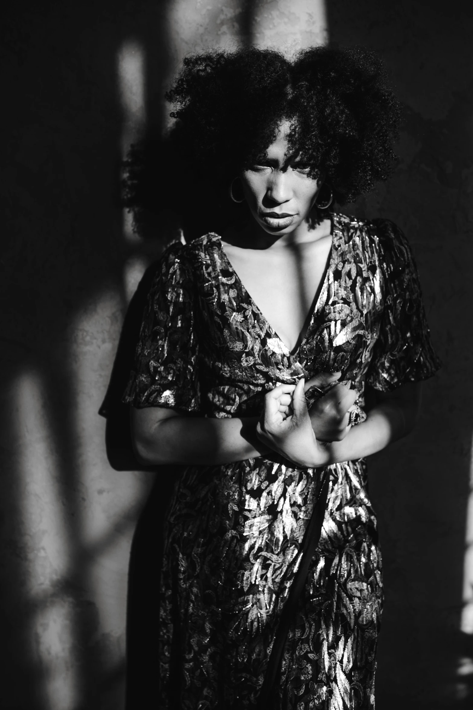 a black and white photo of a woman in a dress, sza, high contrast dappled lighting, hands, (dark shorter curly hair)