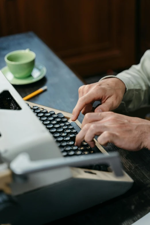 a close up of a person typing on a typewriter, a digital rendering, unsplash, private press, multiple stories, brown, long, getty images