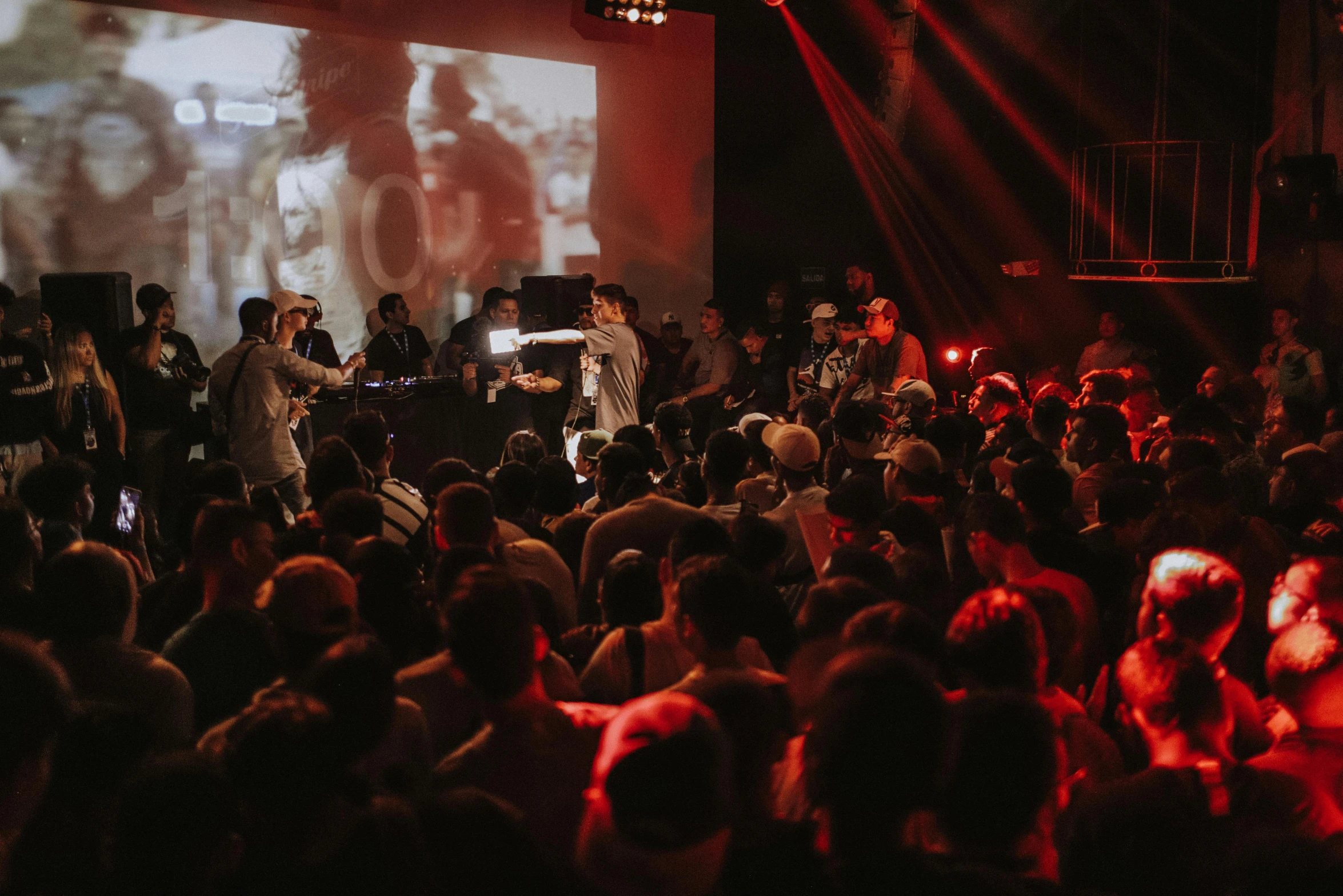 a group of people that are standing in front of a screen, stage at a club, profile image, thumbnail, jordan grimmer and james jean