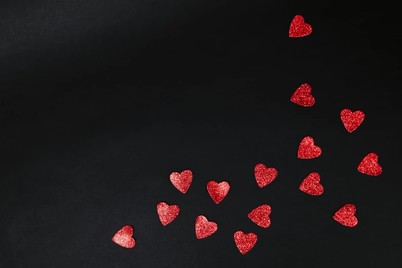 red glitter hearts on a black background, an album cover, pexels contest winner, background image, miniature product photo, 15081959 21121991 01012000 4k, thumbnail